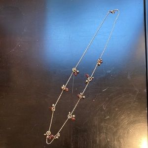 Long gold-toned chain statement necklace with brown stationary beads